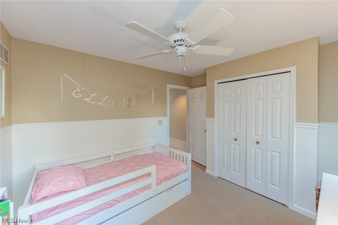 603 Literary Road Cleveland, OH 44113 - Photo 19 of 35 Unfurnished bedroom featuring light colored carpet, a closet, and ceiling fan