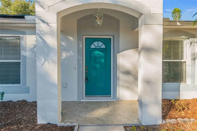 an empty room with a ceiling fan and wooden floor