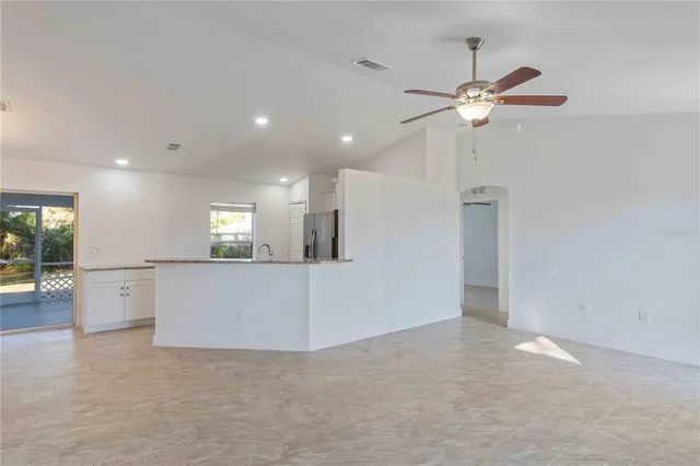 a kitchen with refrigerator and window