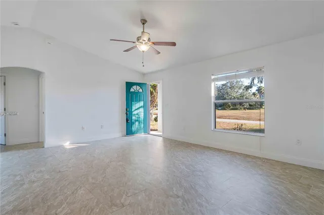 a view of a refrigerator a sink and a window