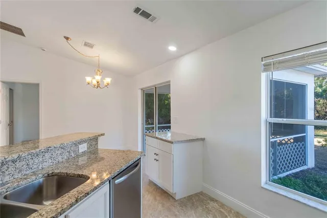 a kitchen with stainless steel appliances granite countertop a refrigerator a oven a sink and dishwasher