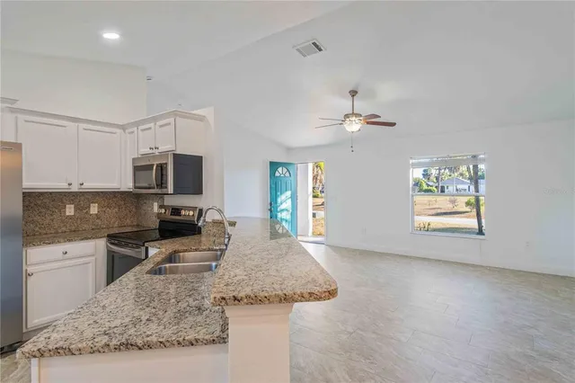view of a kitchen with a sink and a window