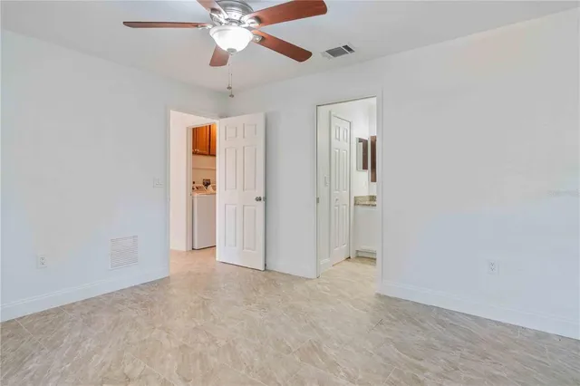 a bathroom with a granite countertop sink a toilet and a mirror