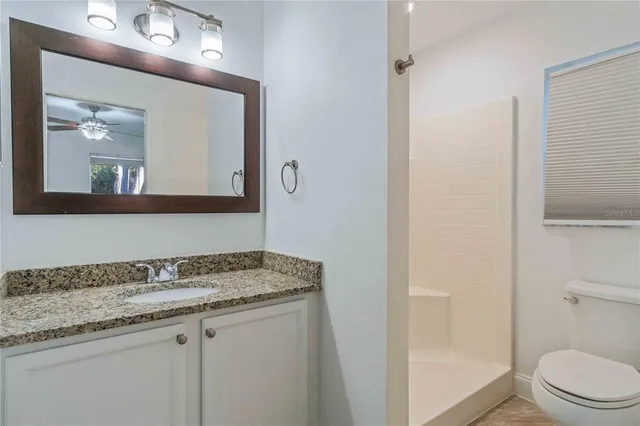 a bathroom with a granite countertop and sink