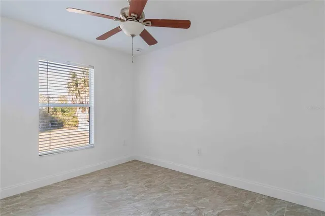 a bathroom with a granite countertop sink toilet mirror vanity and shower
