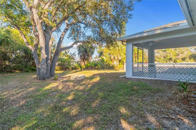 a view of a yard with a tree