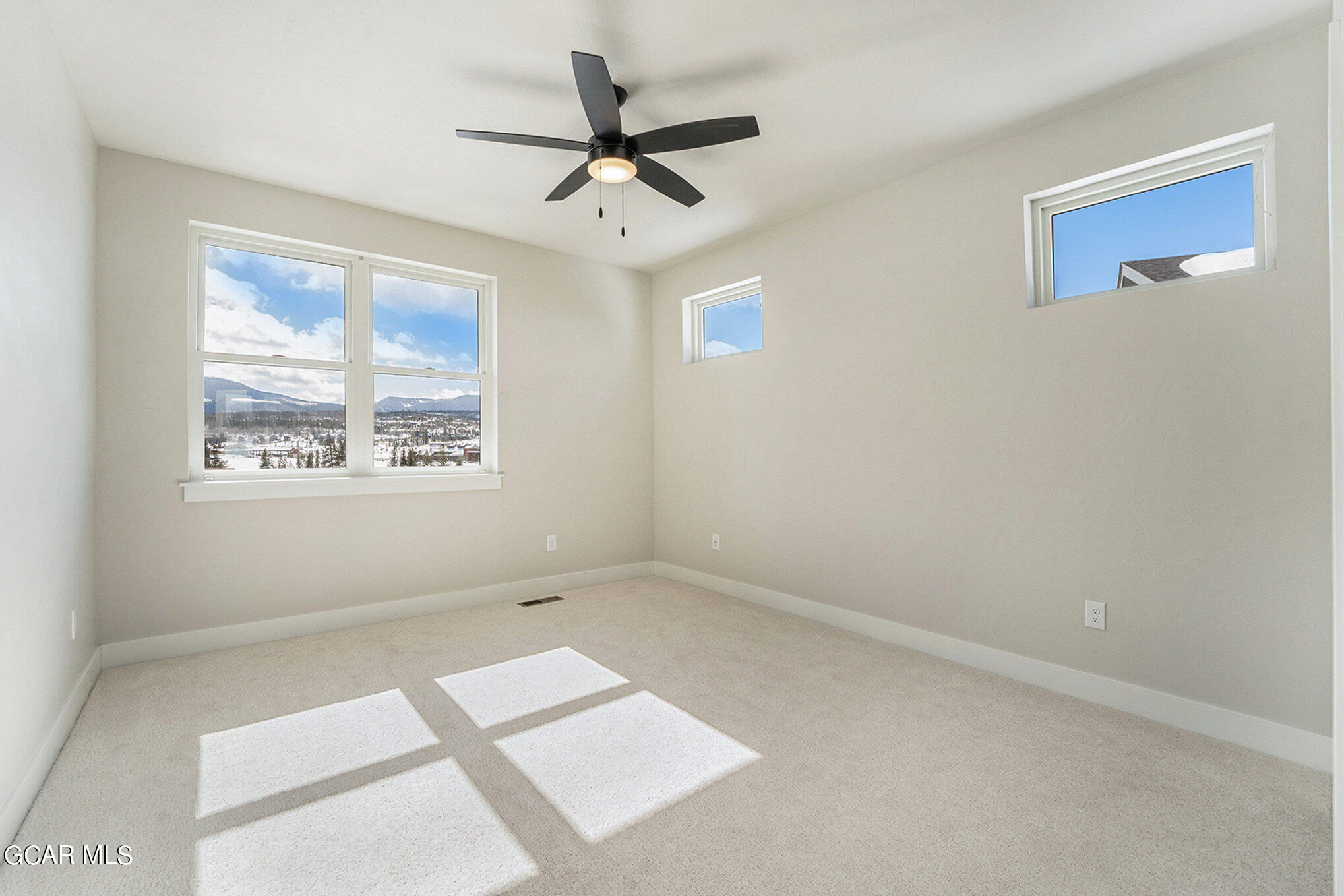 186 Homestead Loop Fraser, CO 80442 - Photo 14 of 29 an empty room with a window and a ceiling fan
