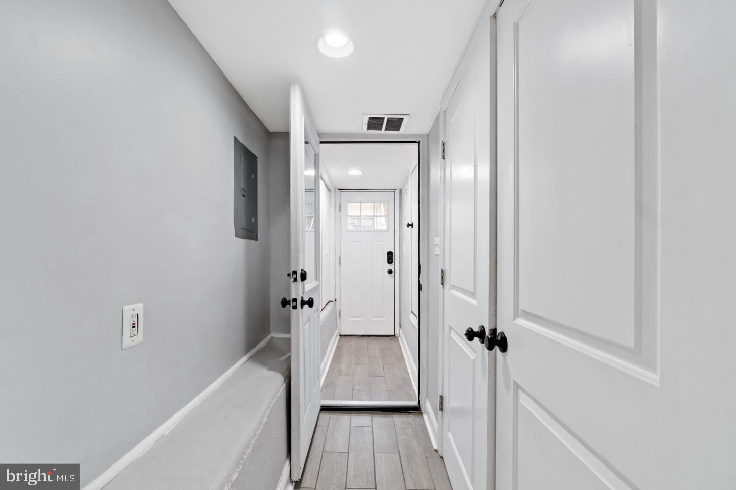 3416 Toone Street Baltimore, MD 21224 - Photo 13 of 18 a view of a hallway with wooden floor and a bathroom