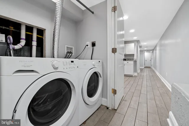 a view of a hallway with washer and dryer