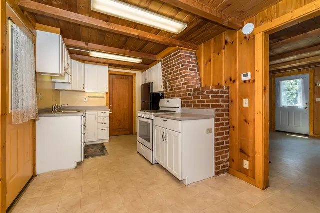 a kitchen with stainless steel appliances granite countertop a sink and cabinets