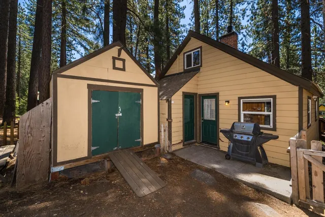 a view of a house with backyard stove and sitting area