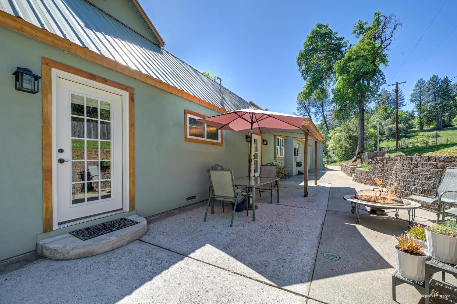 3240 Lone Star Mine Road Placerville, CA 95667 - Photo 45 of 59 a view of a patio with a table and chairs under an umbrella