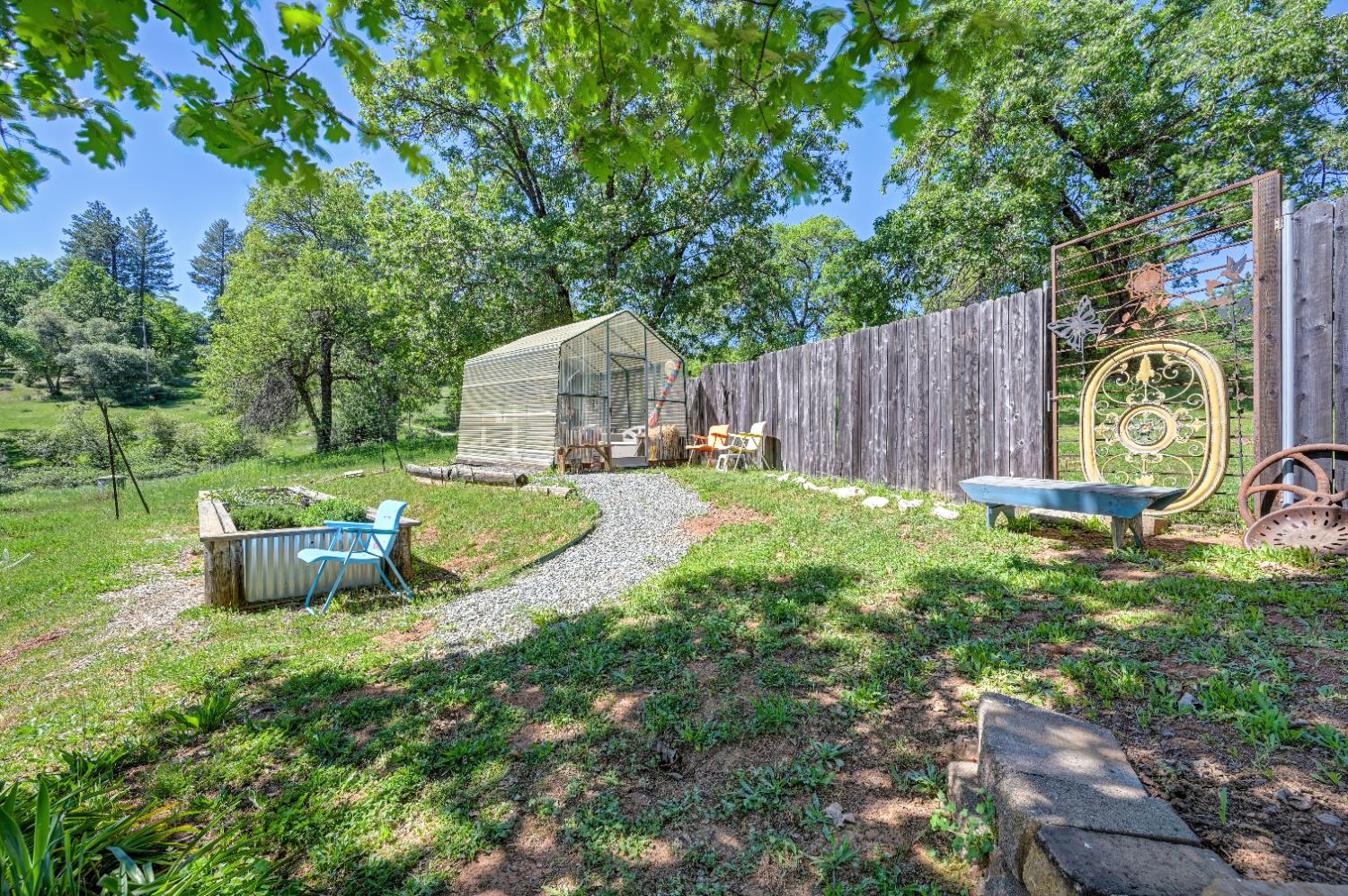 3240 Lone Star Mine Road Placerville, CA 95667 - Photo 56 of 59 a view of a backyard with table and chairs and wooden fence