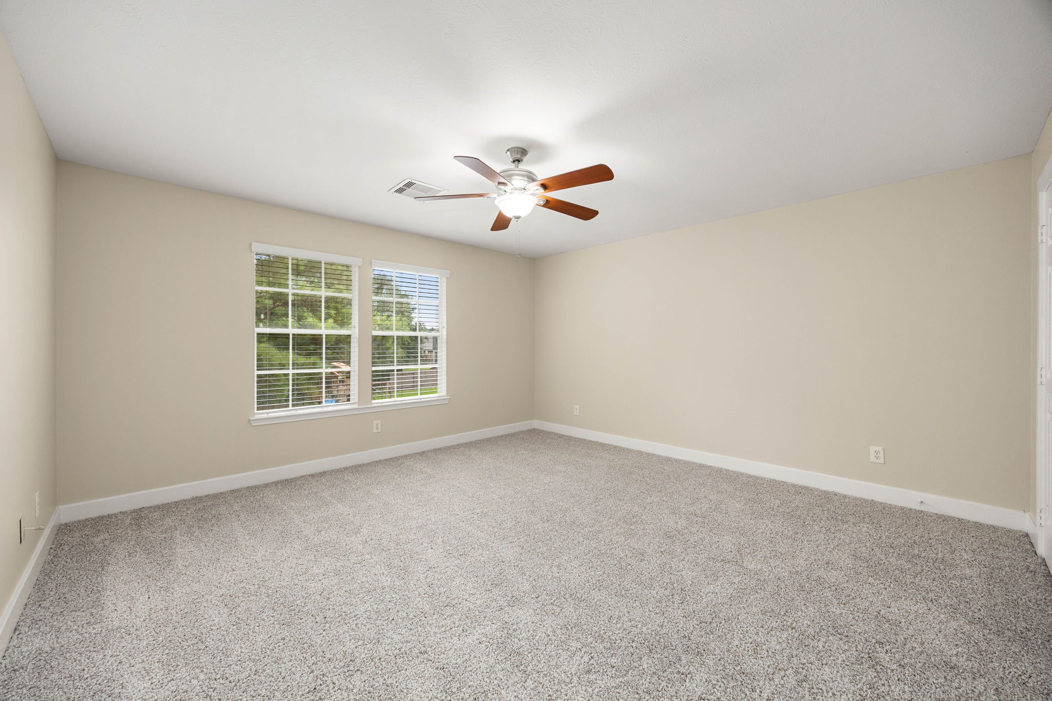 6335 Borg Breakpoint Drive Spring, TX 77379 - Photo 26 of 39 Bright secondary bedroom featuring plush carpet, ceiling fan, and natural light.
