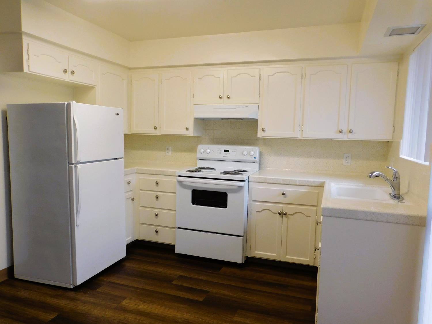 548 West Clinton Avenue Fresno, CA 93705 - Photo 2 of 7 a kitchen with a refrigerator sink and cabinets