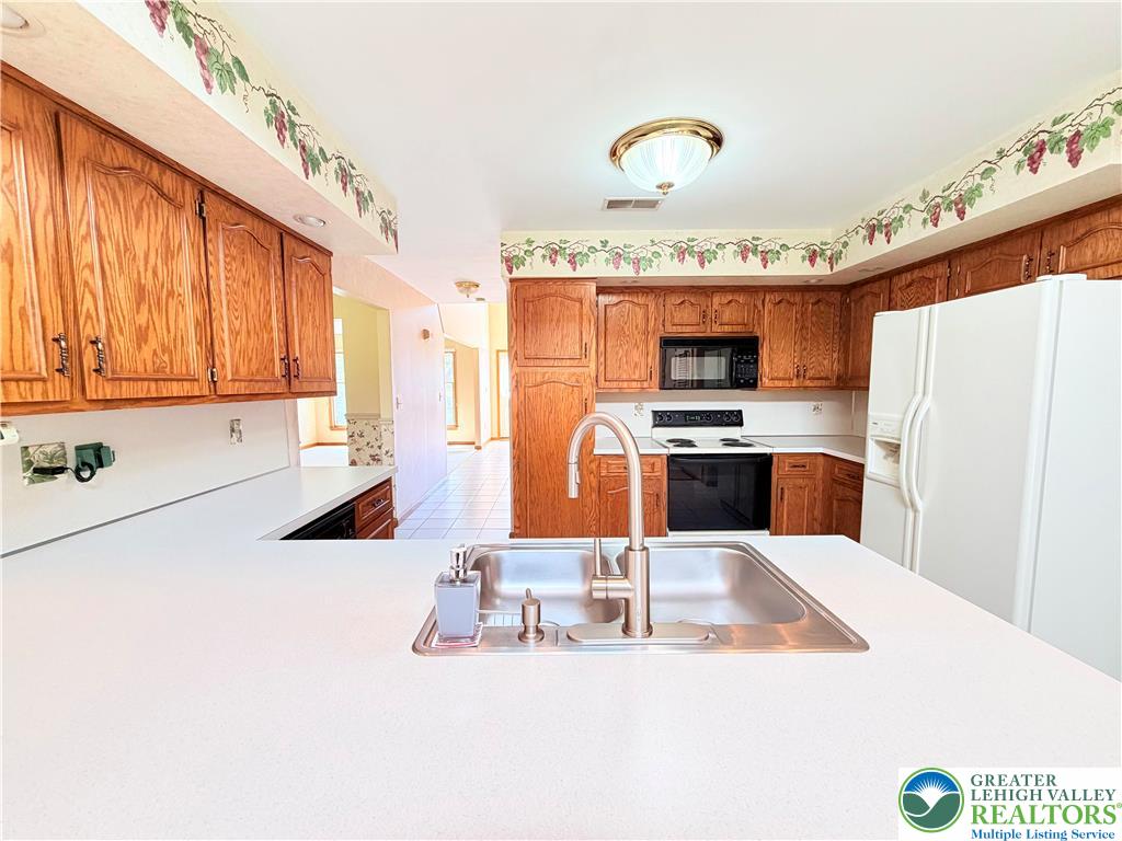 4165 Alder Road Bethlehem, PA 18020 - Photo 11 of 42 a kitchen with stainless steel appliances granite countertop a sink and a refrigerator