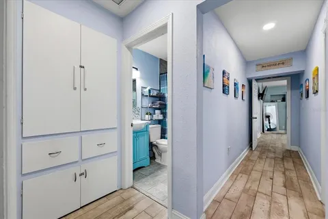 a view of a hallway to room with hallway and wooden floor