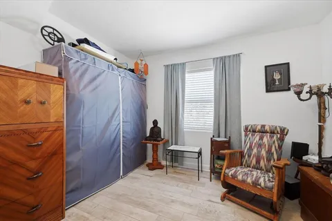 a bedroom with a bed and a chair