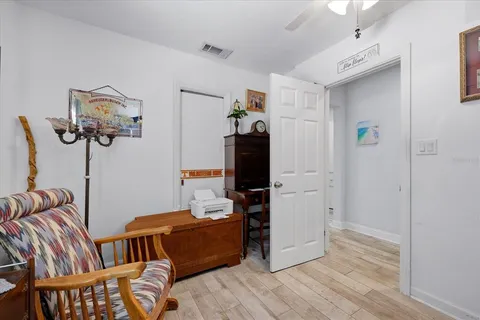 a bedroom with furniture and wooden floor
