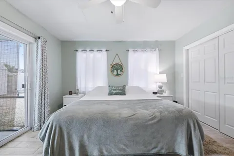 a bedroom with a bed and a lamp on dresser