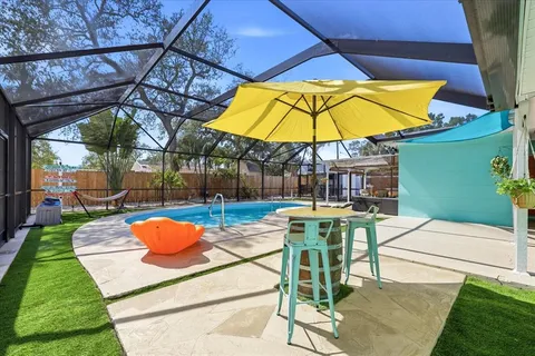 a view of backyard of a patio and swimming pool