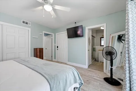 a bedroom with a bed and a mirror