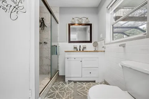 a bathroom with a toilet sink and mirror