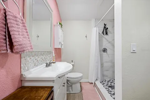 a bathroom with a sink toilet and shower