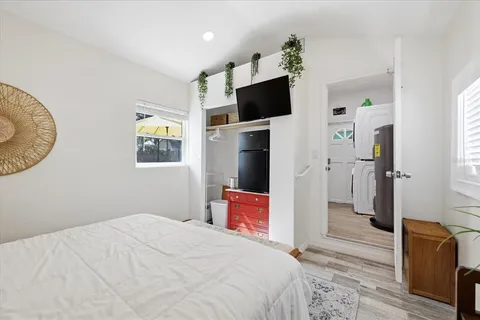 a bedroom with a bed and a flat screen tv