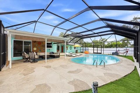 a view of a swimming pool with chair and table
