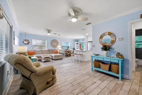 a living room with furniture a rug and a chandelier