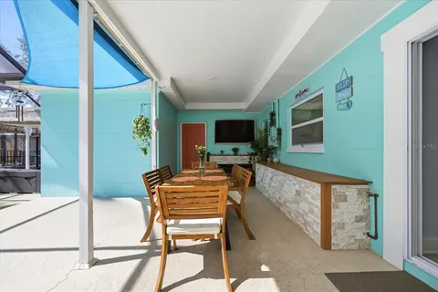 a dining room with furniture and a flat screen tv