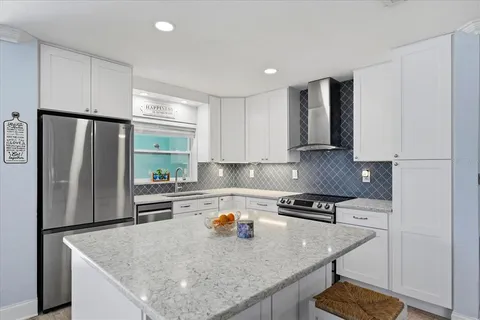 a kitchen with stainless steel appliances granite countertop refrigerator sink stove and microwave