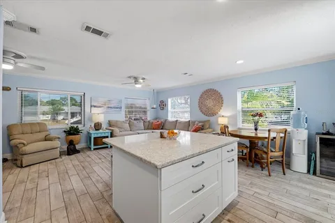 a room with furniture a dining table and a large window