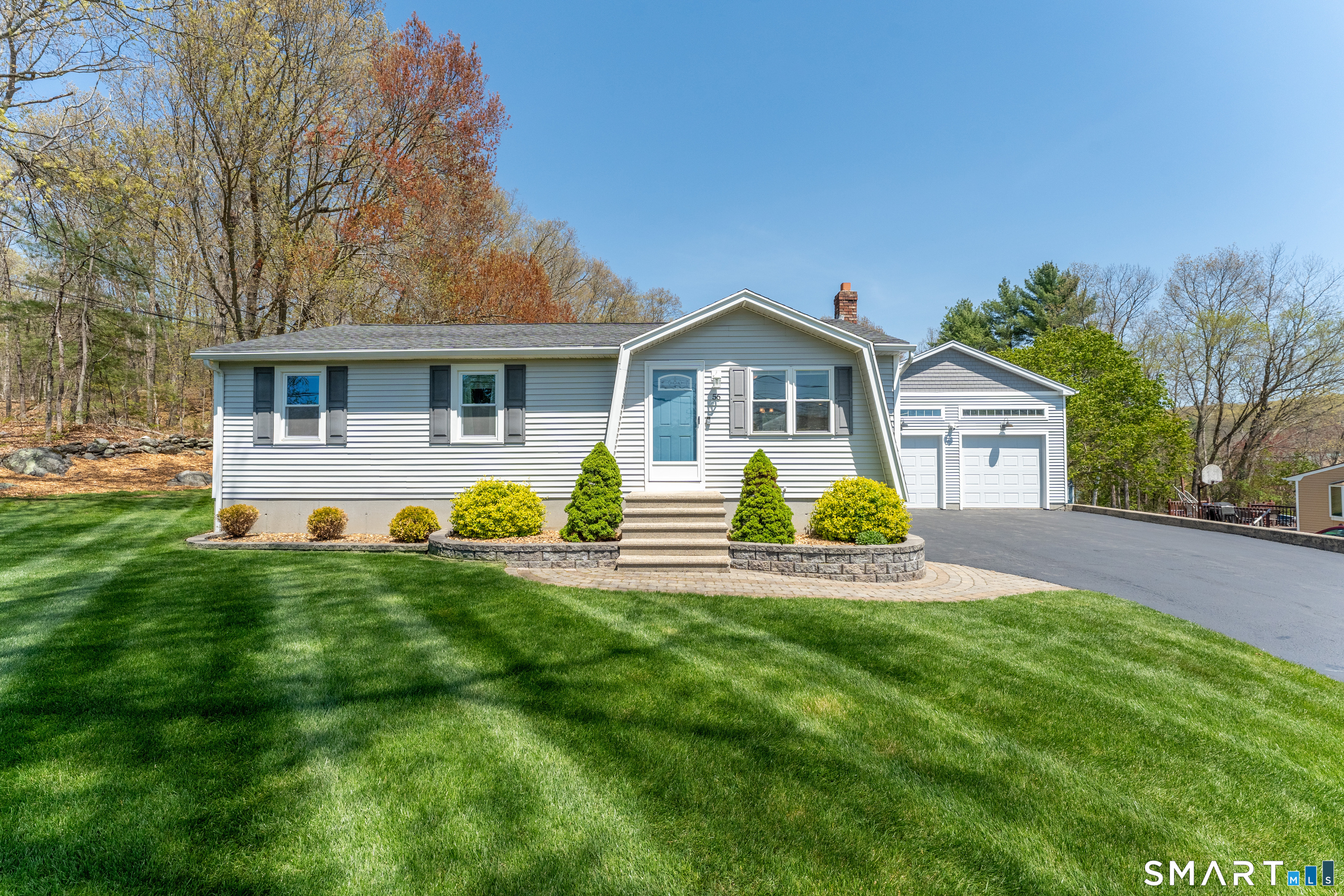 a front view of house with yard and green space