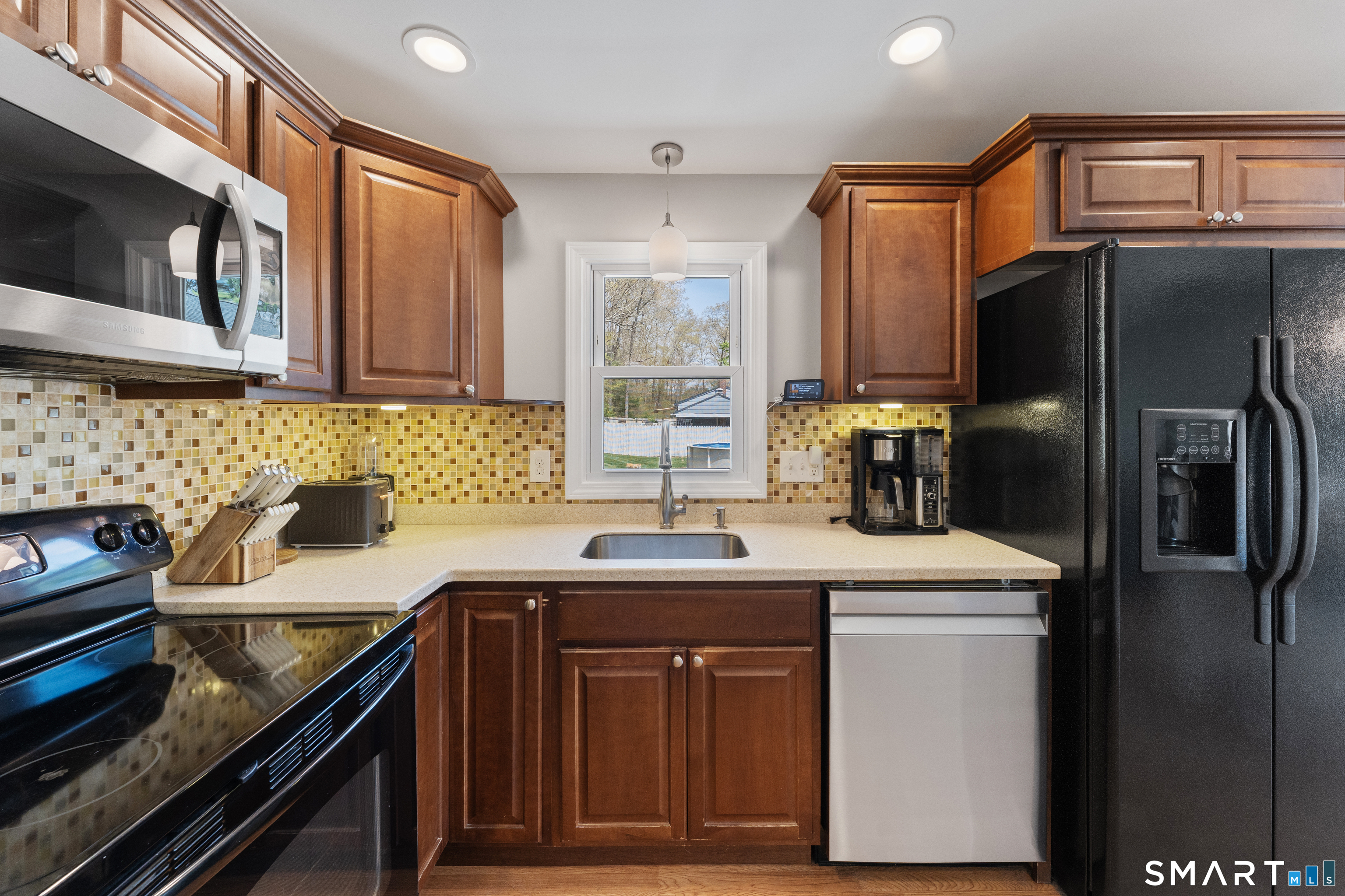 56 Thompson Hill Road Thompson, CT 06255 - Photo 13 of 38 a kitchen with stainless steel appliances a sink stove and refrigerator