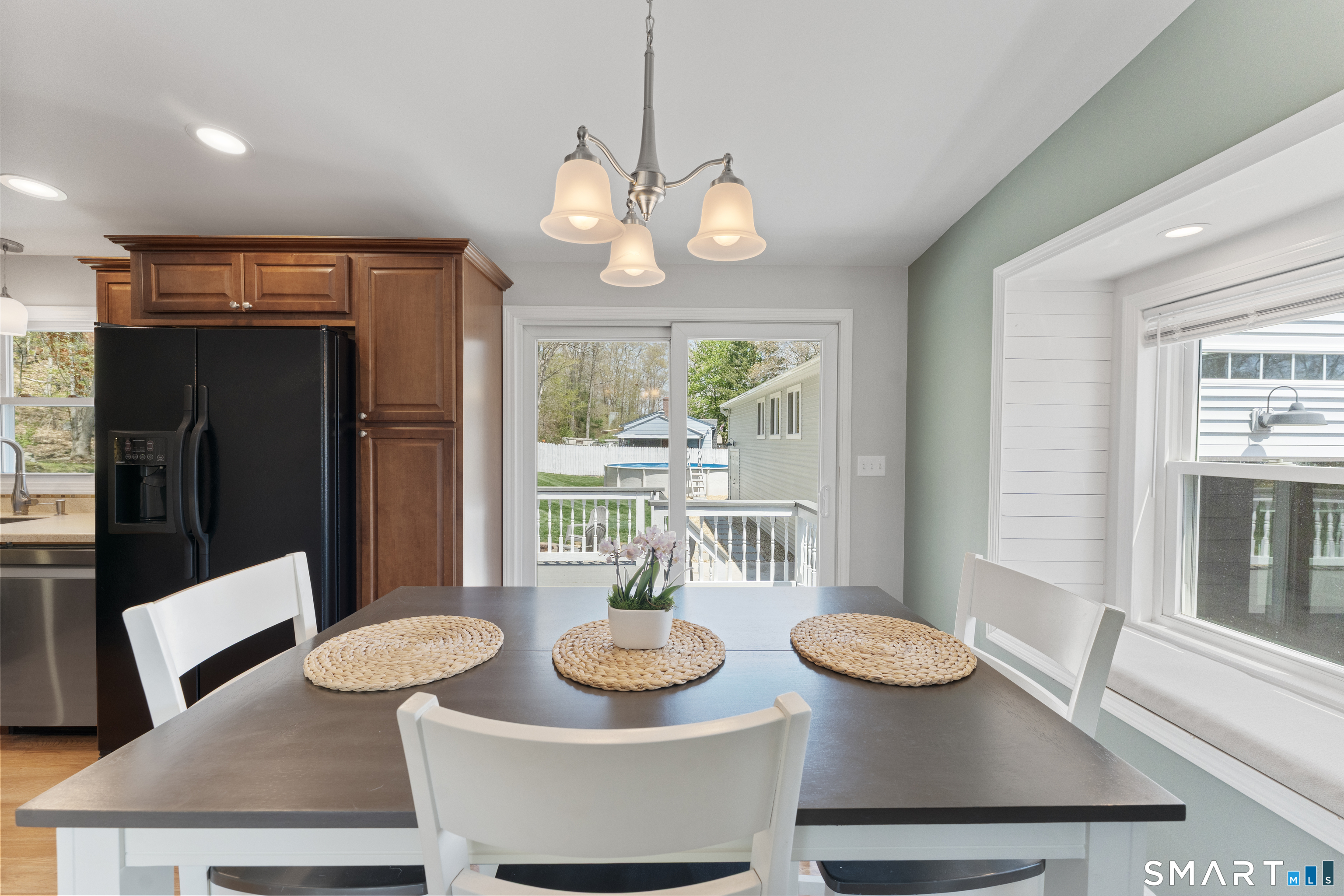 56 Thompson Hill Road Thompson, CT 06255 - Photo 14 of 38 a view of a dining room with furniture a kitchen and chandelier