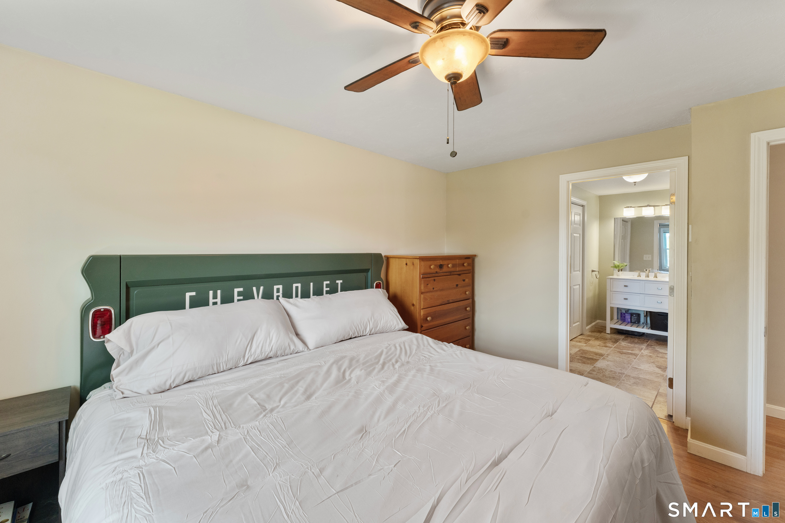56 Thompson Hill Road Thompson, CT 06255 - Photo 21 of 38 a bedroom with a bed and a chandelier