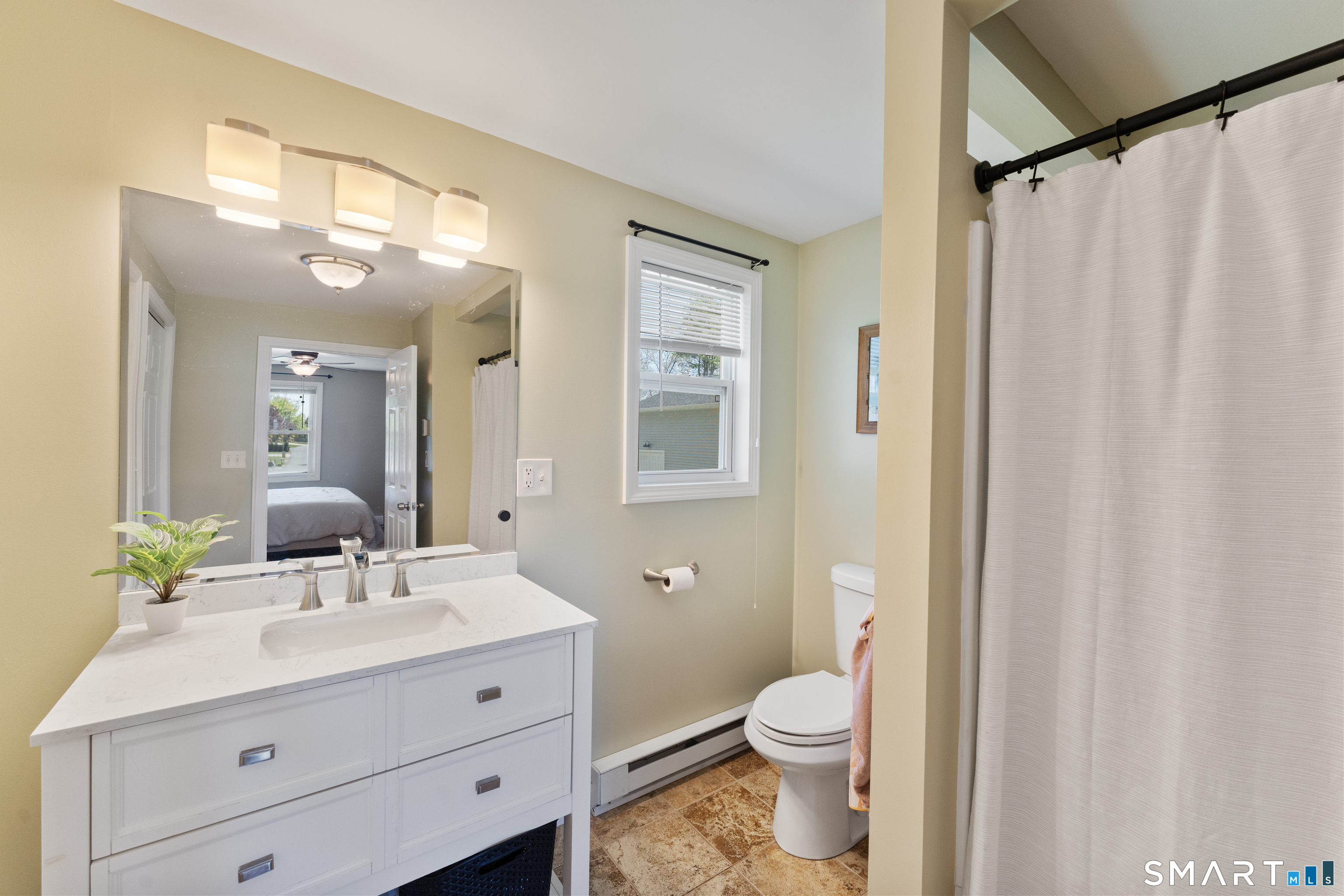 56 Thompson Hill Road Thompson, CT 06255 - Photo 23 of 38 a bathroom with a toilet a sink a and a mirror