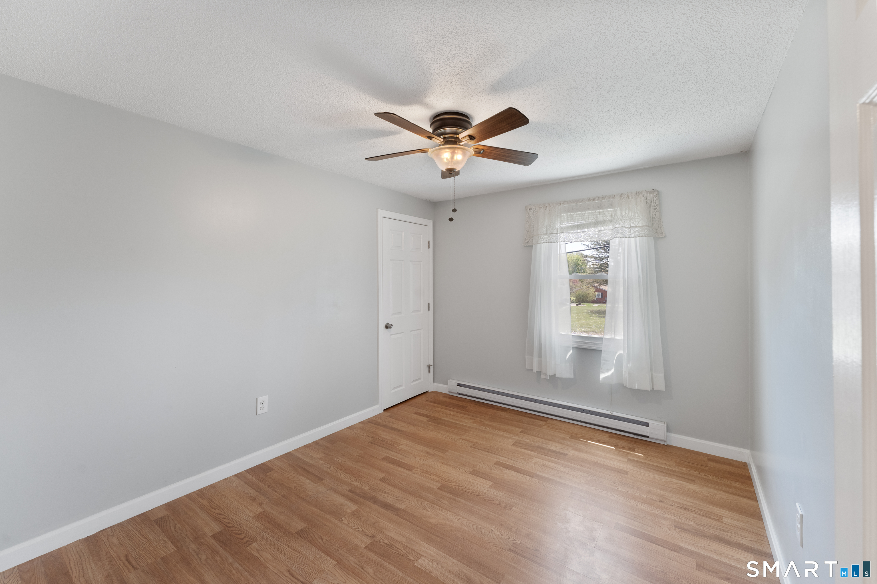 56 Thompson Hill Road Thompson, CT 06255 - Photo 24 of 38 wooden floor in an empty room with a window