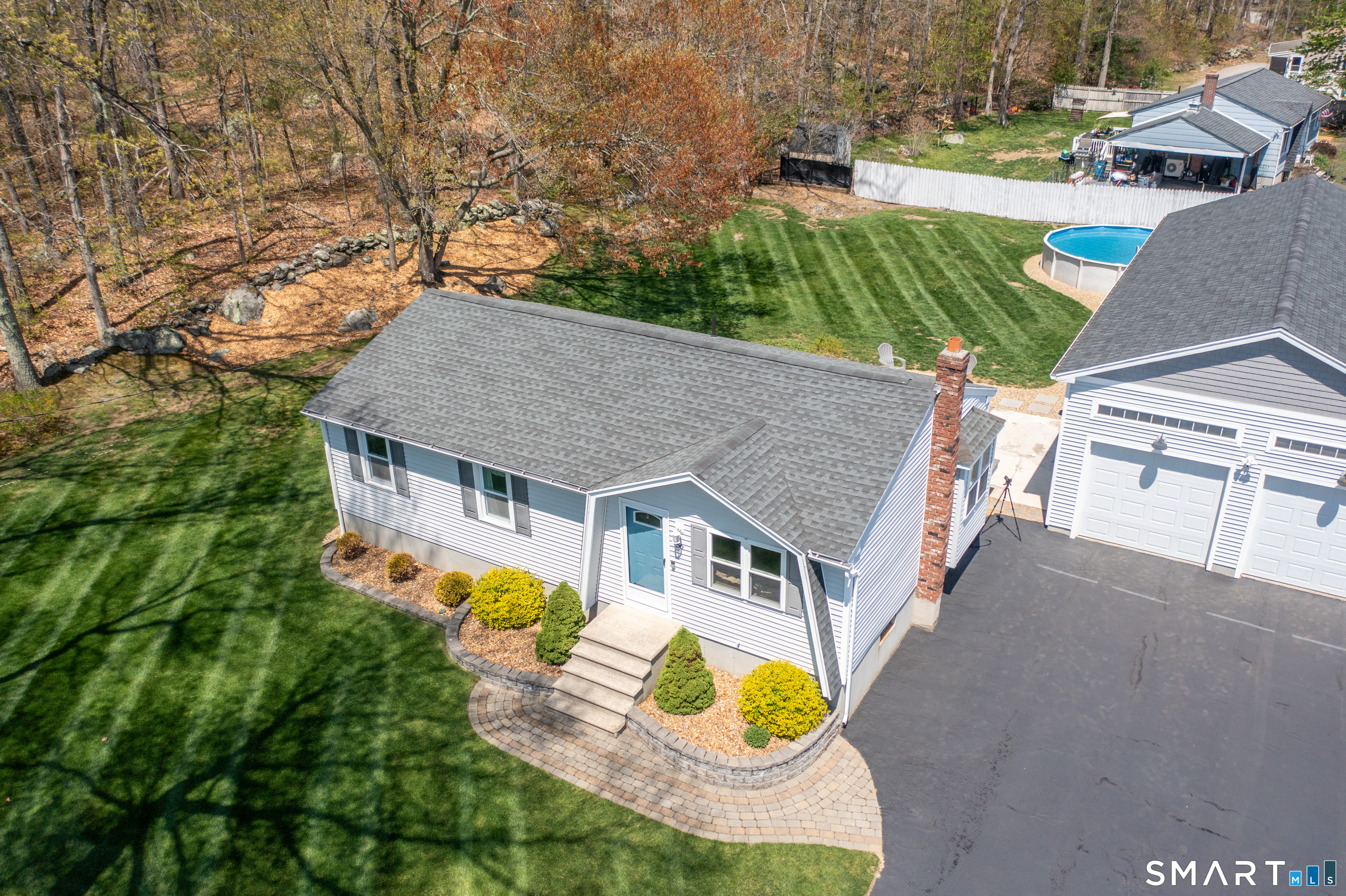 56 Thompson Hill Road Thompson, CT 06255 - Photo 29 of 38 an aerial view of a house with swimming pool and large trees