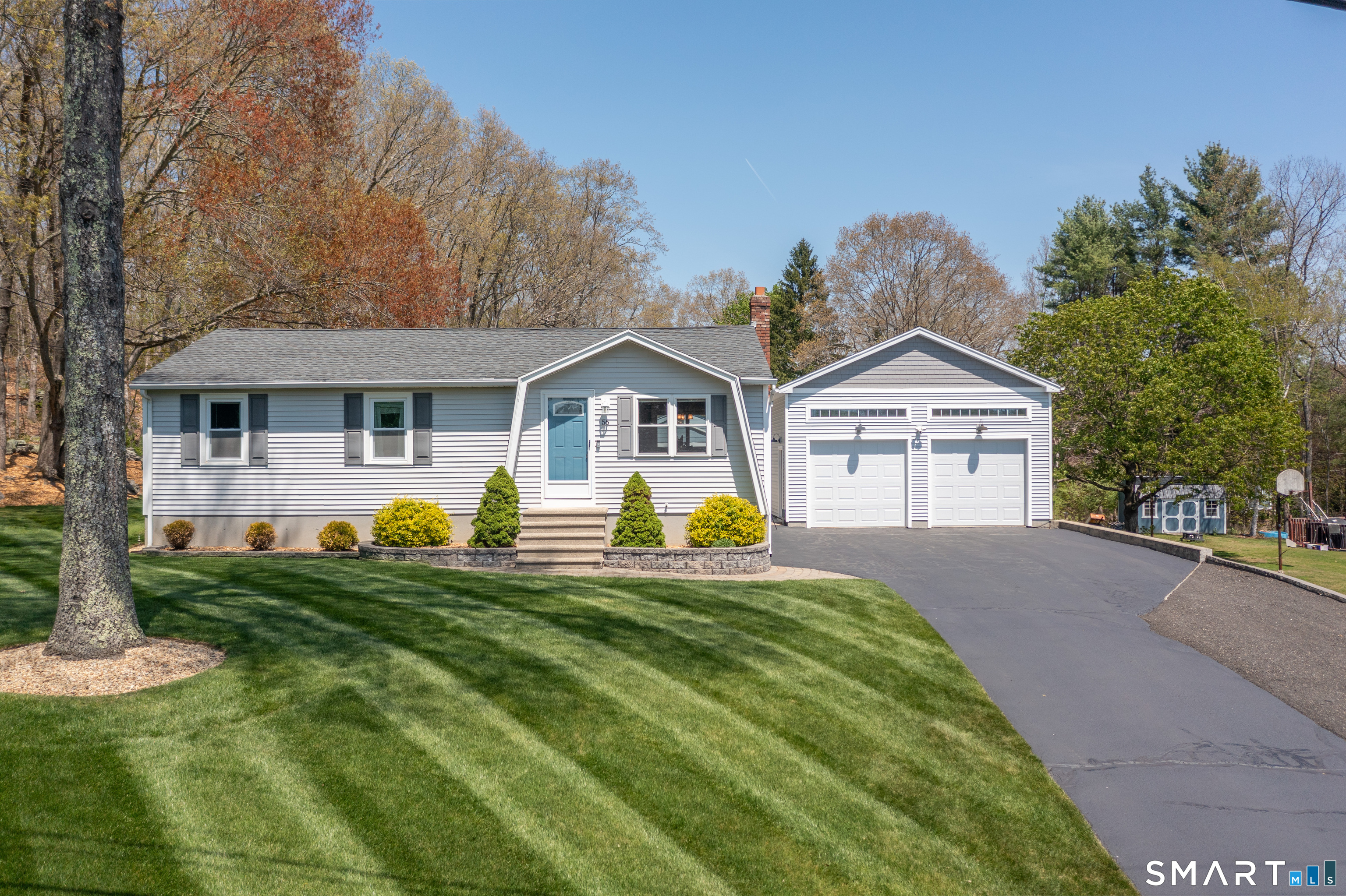 56 Thompson Hill Road Thompson, CT 06255 - Photo 3 of 38 a front view of a house with a yard and garage