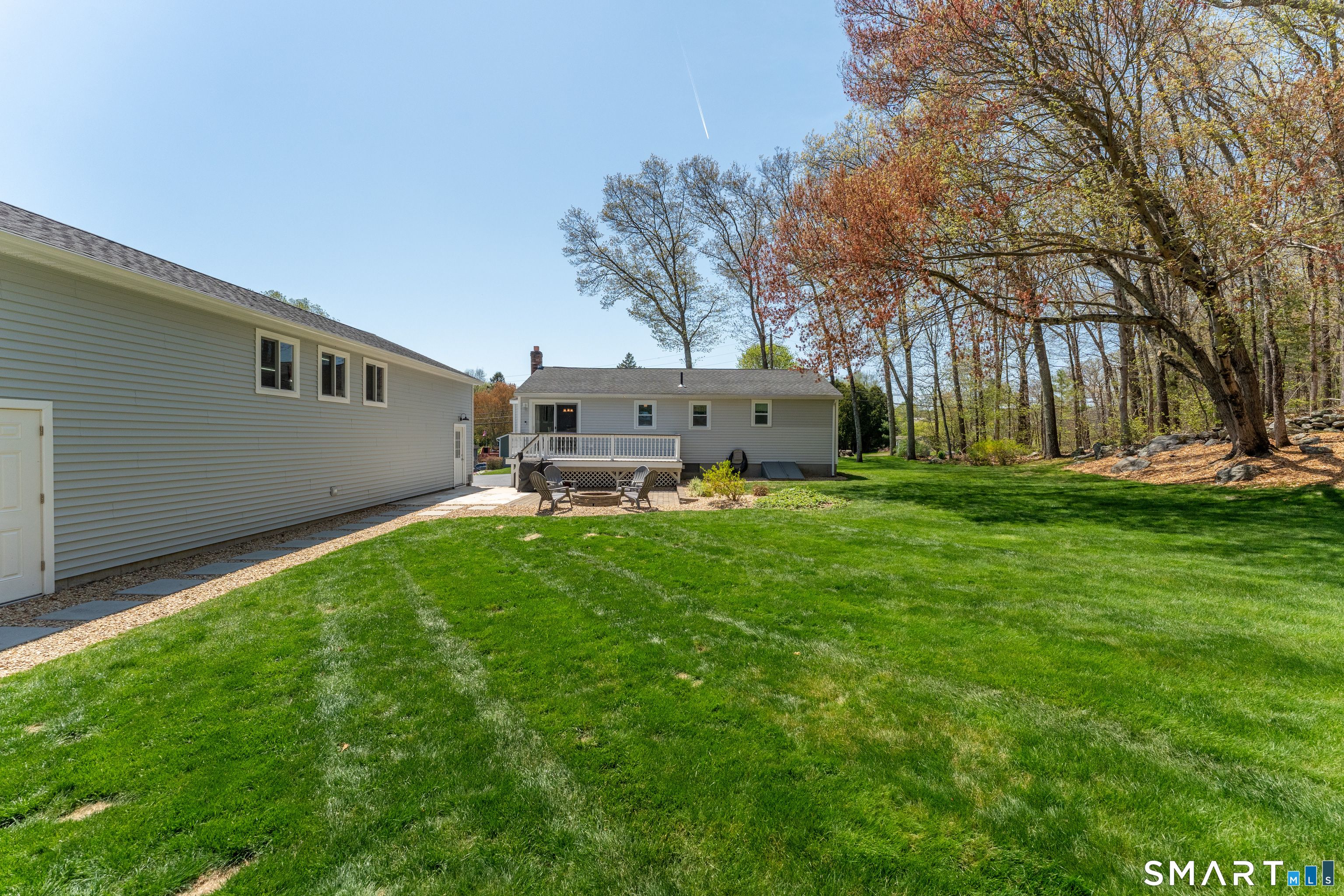 56 Thompson Hill Road Thompson, CT 06255 - Photo 33 of 38 a backyard of a house with table and chairs