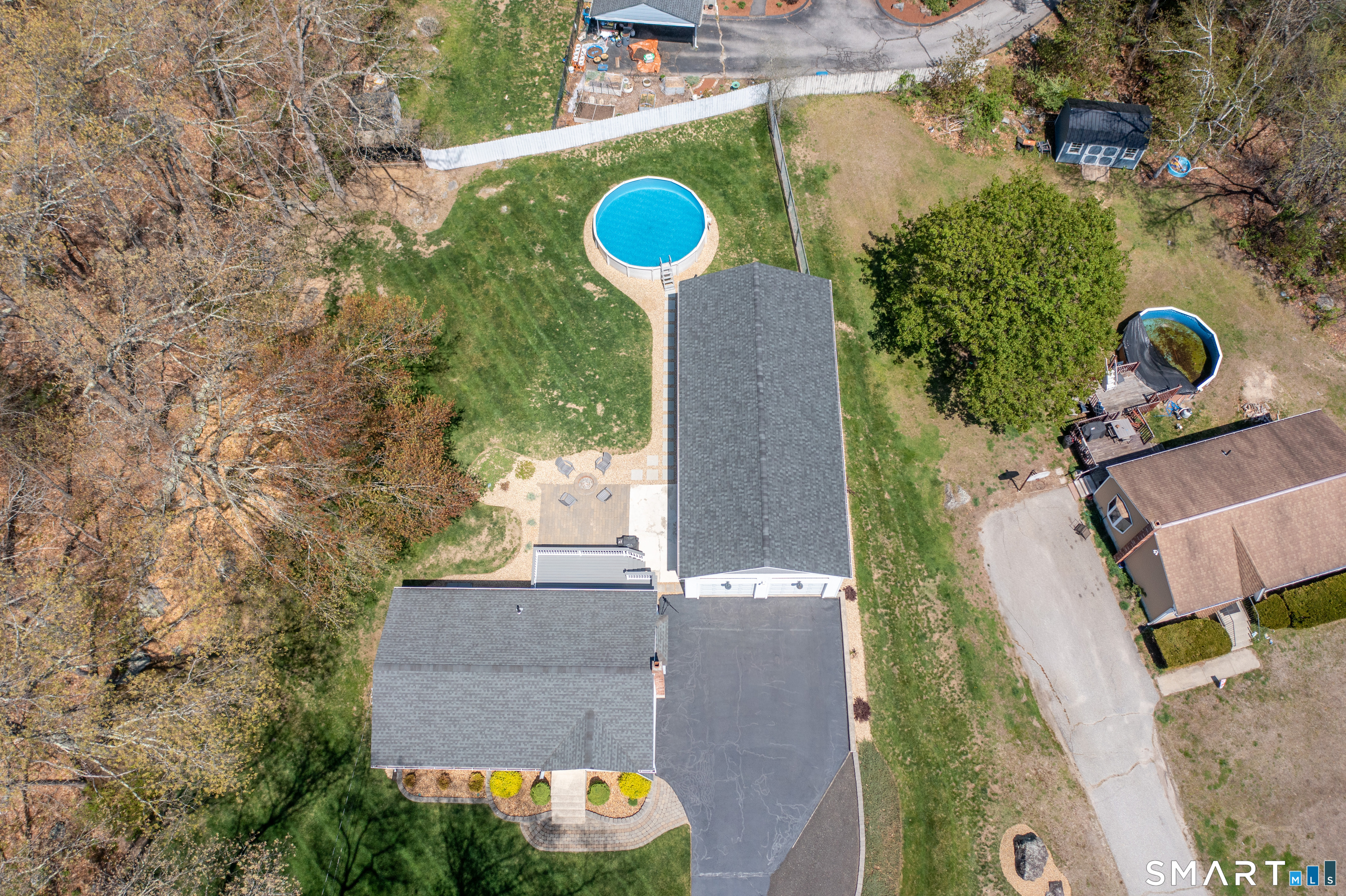 56 Thompson Hill Road Thompson, CT 06255 - Photo 36 of 38 an aerial view of a house with a yard and a large tree
