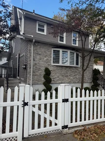 a view of a house with wooden fence