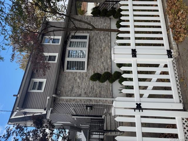 a view of a house with wooden fence