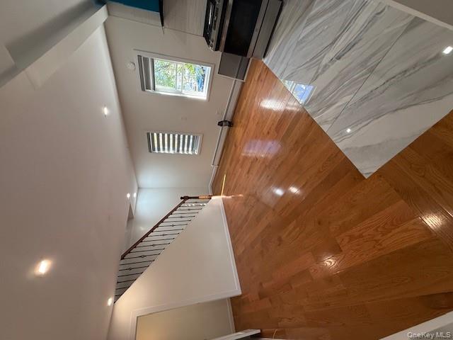 90-19 107th Avenue, Unit 2 Queens, NY 11417 - Photo 4 of 12 a view of an empty room with wooden floor and a window
