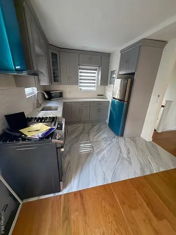 a kitchen with a sink appliances and cabinets