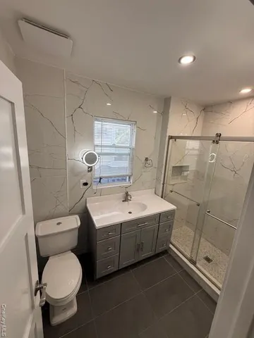 a bathroom with a sink toilet and shower