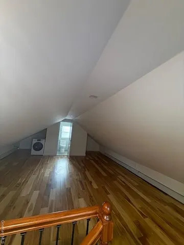 a view of a room with wooden floor